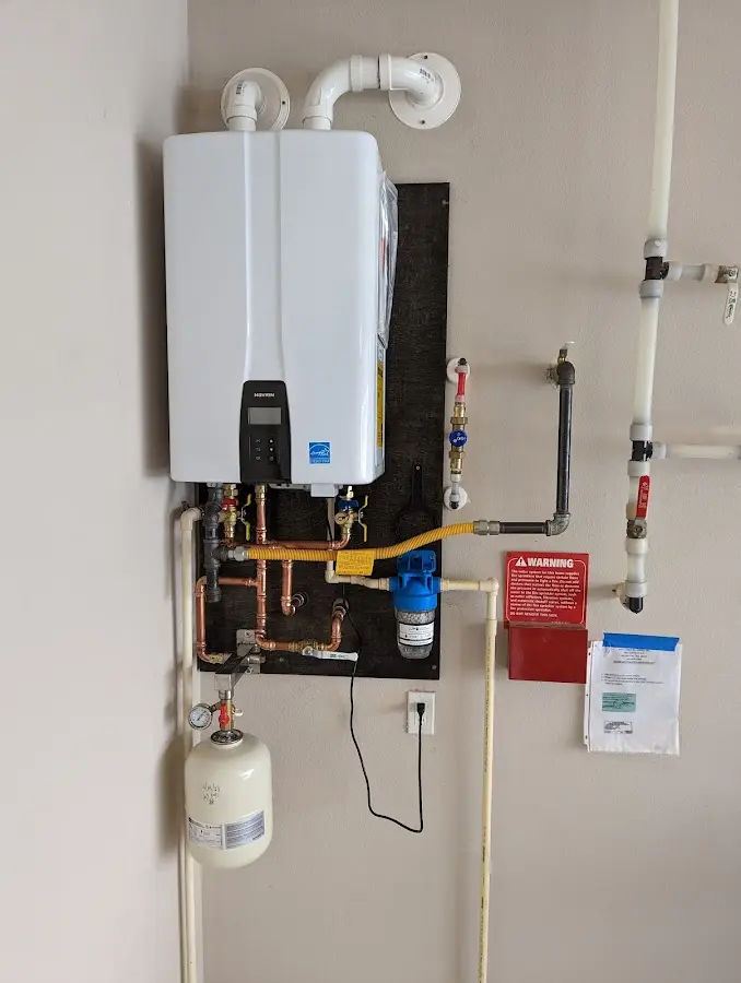 Professional plumber installing copper piping in a Montpelier home